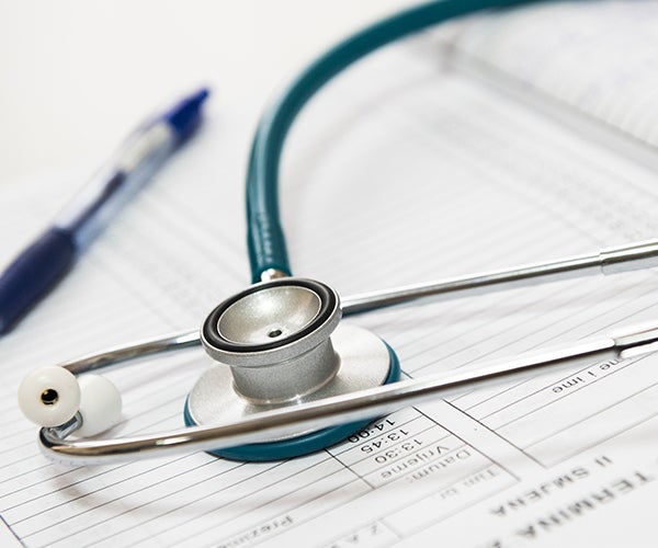 A stethoscope on sits on top of a form