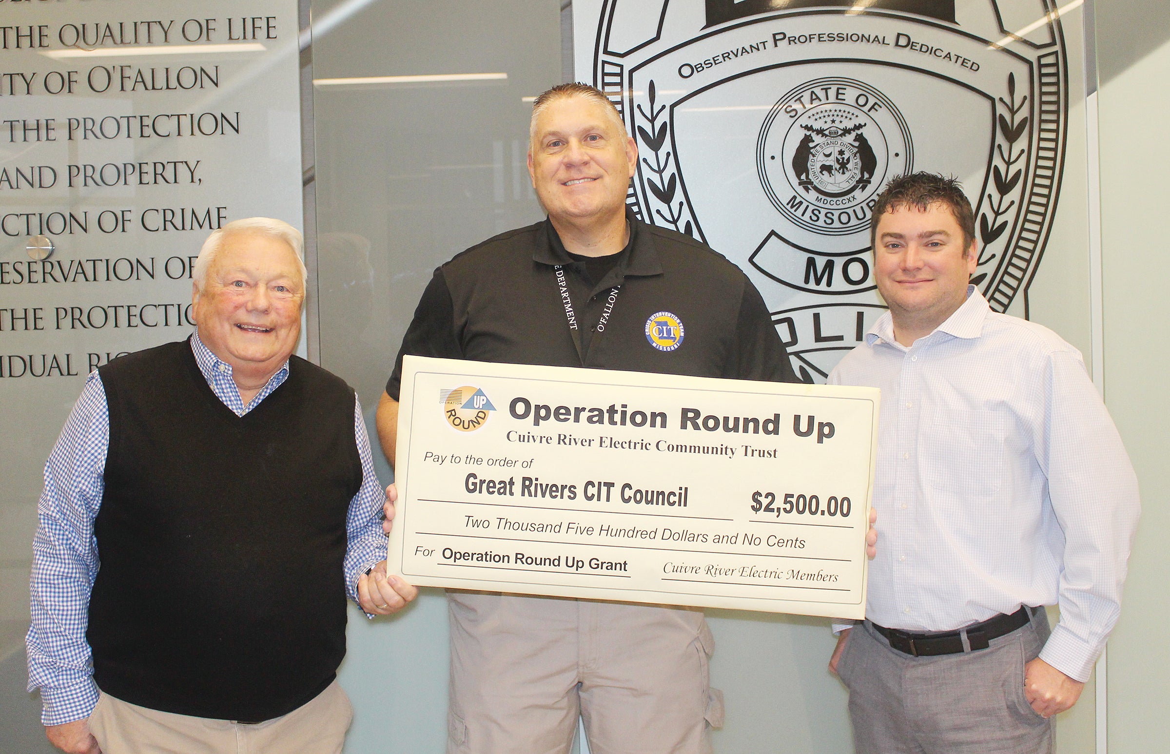 The Great Rivers Crisis Intervention Team accepts a $2,500 check from Operation Round Up