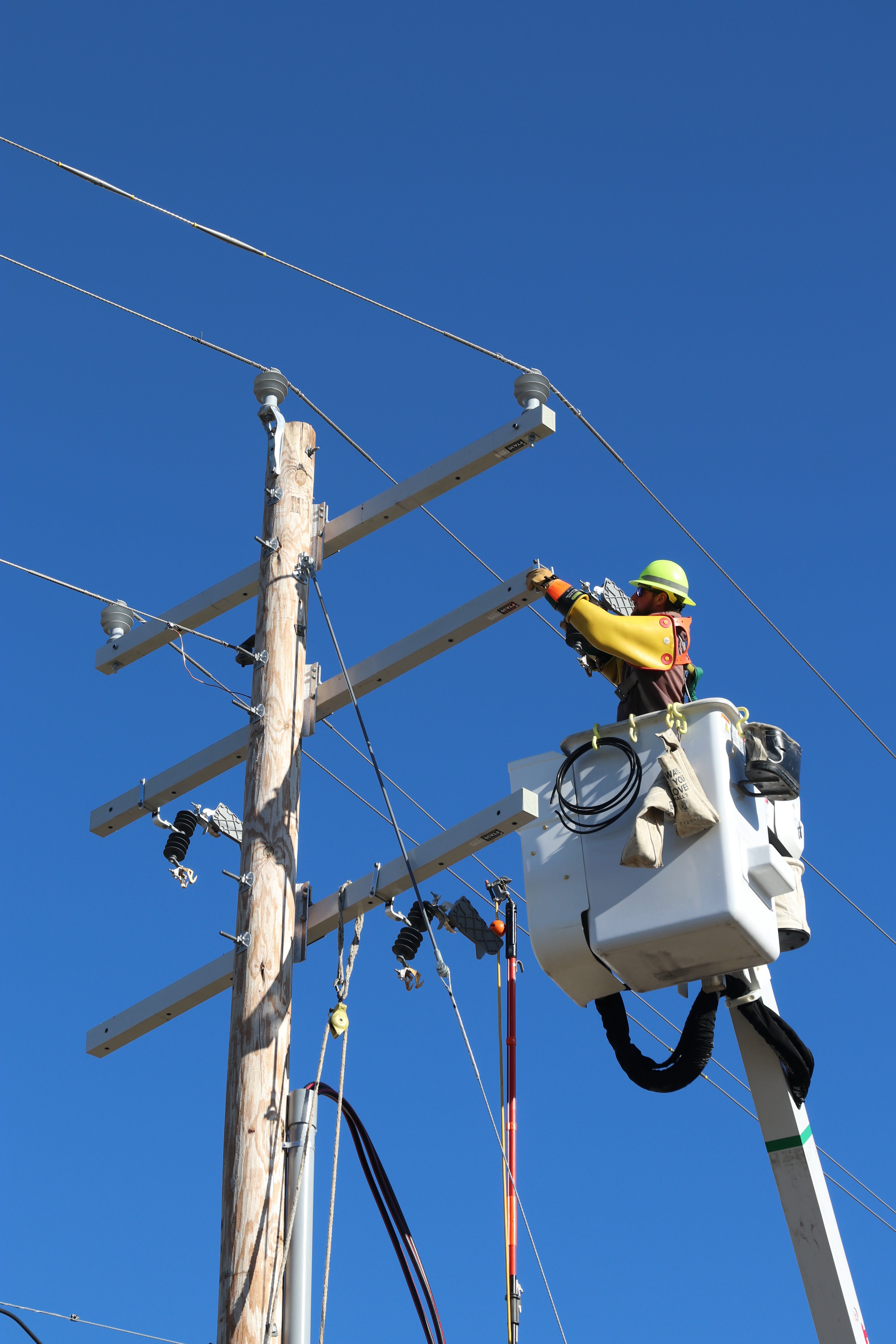 CREC linemen James Walker works on overhead line improvements.