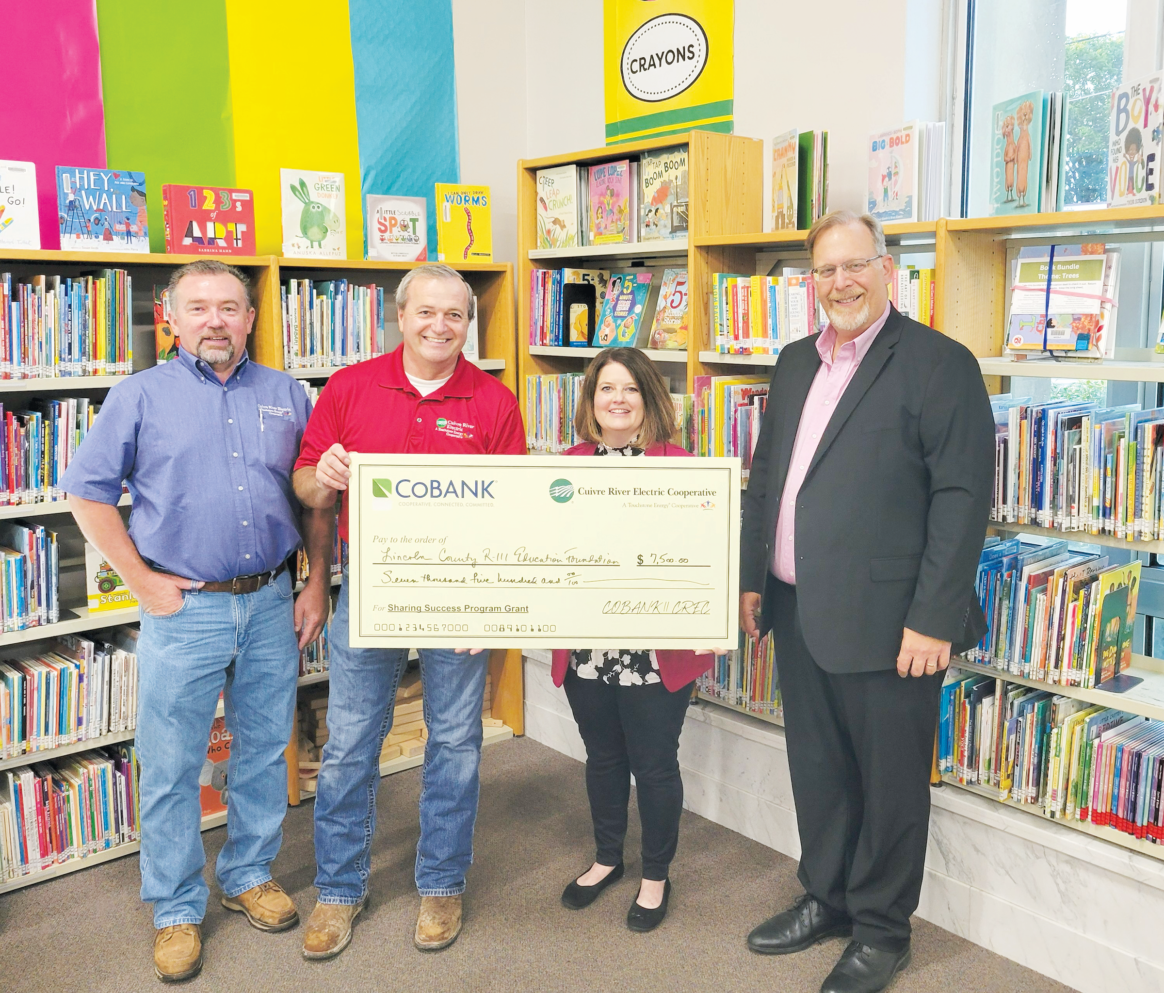 From left, Jeff Geisendorfer, Mike Cherry, Cuivre River Electric board directors; Valerie Levy, librarian, Powell Memorial Library, and Dr. Matt Frederickson, superintendent, both of Lincoln County R-III School District.