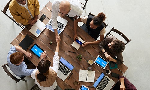 Members sit around a table