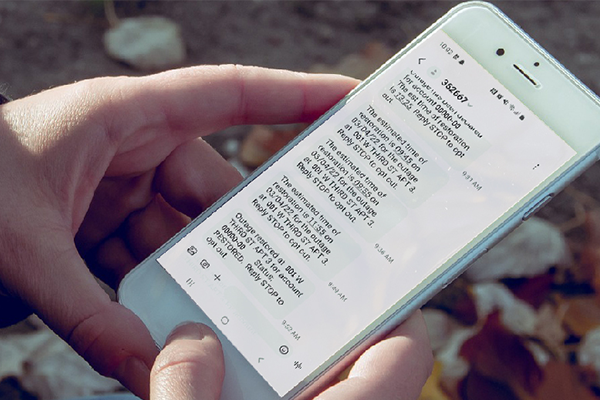 A person checks outage alerts on their phone.