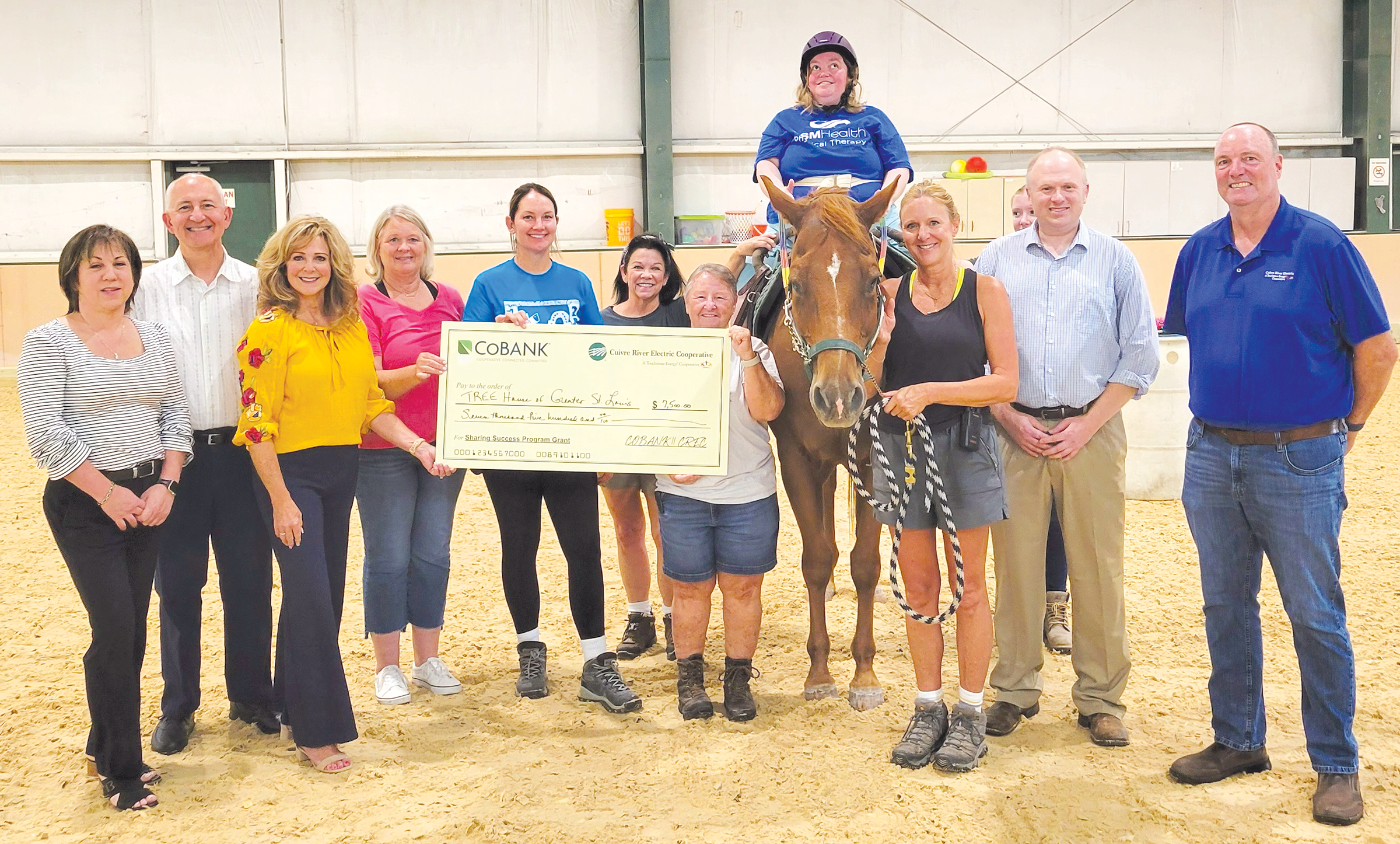 From left, CREC Board Directors Karen Berra, Ted House, Diane Saale (president); from TREE House of Greater St. Louis, Shelly N., finance manager; Jamie G., clinical director; Anne K., volunteer sidewalker; Denise P., certified therapeutic riding instructor; client Laura, riding Jack the horse; Cheryl B., aide; Abigail K., volunteer sidewalker; Nathan H., Executive Director, and CREC Board Director Tim Welker.