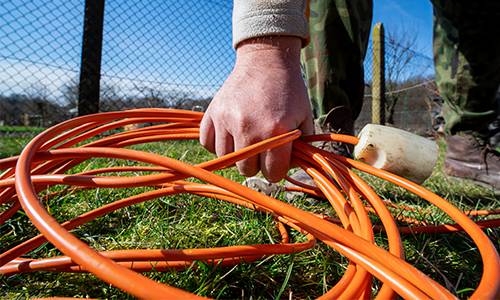 A man picks up an extension cord