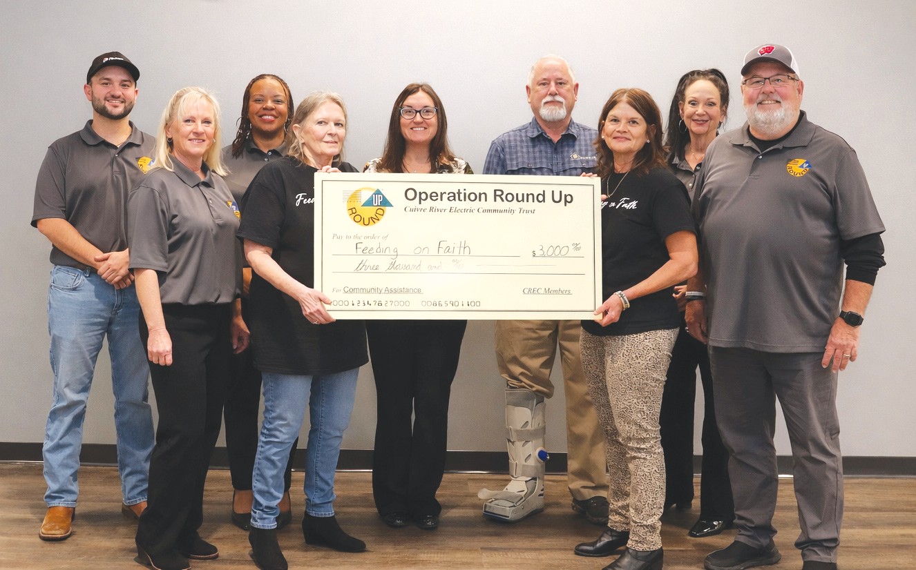 Members of the ORU Board present a check for $3,000 to Feeding on Faith.